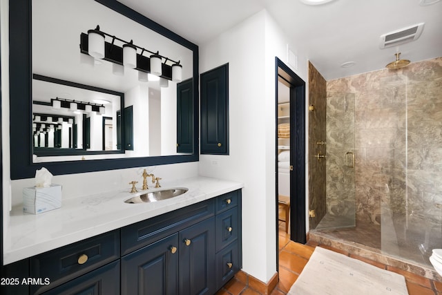 bathroom with tile patterned flooring, vanity, and a shower with shower door