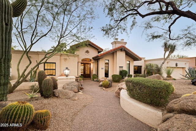 mediterranean / spanish home with a garage