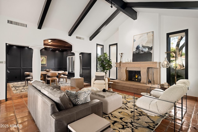 living room featuring beamed ceiling, tile patterned floors, high vaulted ceiling, and decorative columns