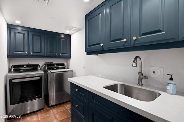 laundry area featuring separate washer and dryer, sink, cabinets, and dark tile patterned flooring