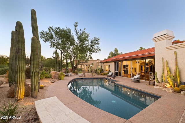 view of swimming pool with a patio area