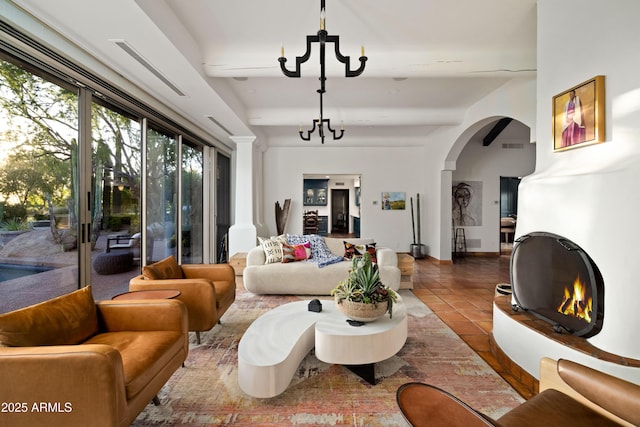 living room with tile patterned floors, a chandelier, and beam ceiling