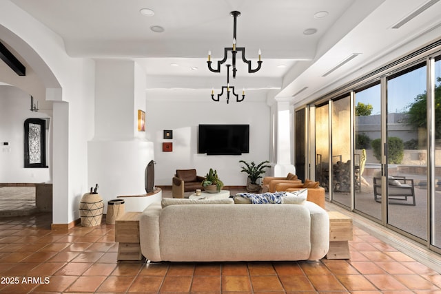 living room featuring tile patterned floors, beam ceiling, and an inviting chandelier