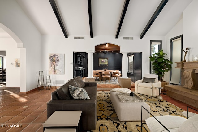 tiled living room featuring lofted ceiling with beams