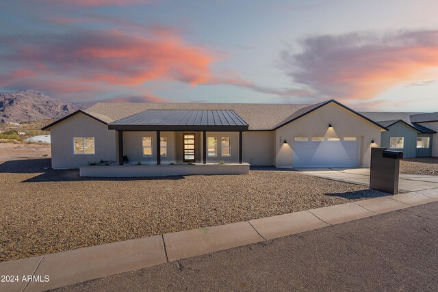 3877 S Veronica Ln, Gold Canyon, AZ 85118 - view of front of home featuring a porch, a garage, driveway, stucco siding, and a mountain view