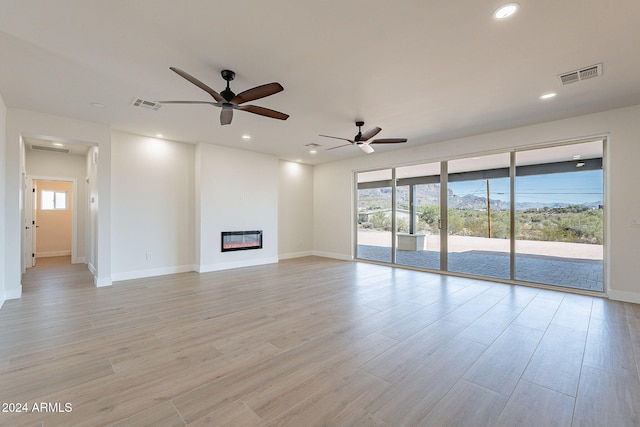 3877 S Veronica Ln, Gold Canyon, AZ 85118 - unfurnished living room with baseboards, a ceiling fan, light wood-style flooring, recessed lighting, and a glass covered fireplace