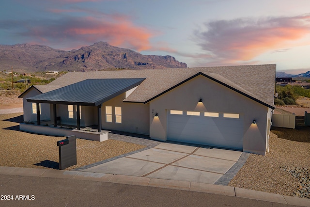 3877 S Veronica Ln, Gold Canyon, AZ 85118 - view of front of home with a mountain view, an attached garage, concrete driveway, and stucco siding