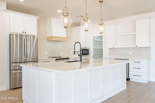 3877 S Veronica Ln, Gold Canyon, AZ 85118 - kitchen featuring stainless steel appliances, open shelves, tasteful backsplash, custom exhaust hood, and a center island with sink