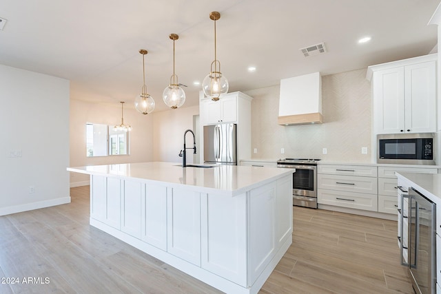 3877 S Veronica Ln, Gold Canyon, AZ 85118 - kitchen with stainless steel appliances, a sink, premium range hood, light countertops, and decorative backsplash