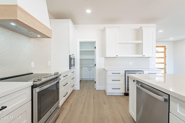 3877 S Veronica Ln, Gold Canyon, AZ 85118 - kitchen featuring appliances with stainless steel finishes, custom range hood, wine cooler, open shelves, and light countertops