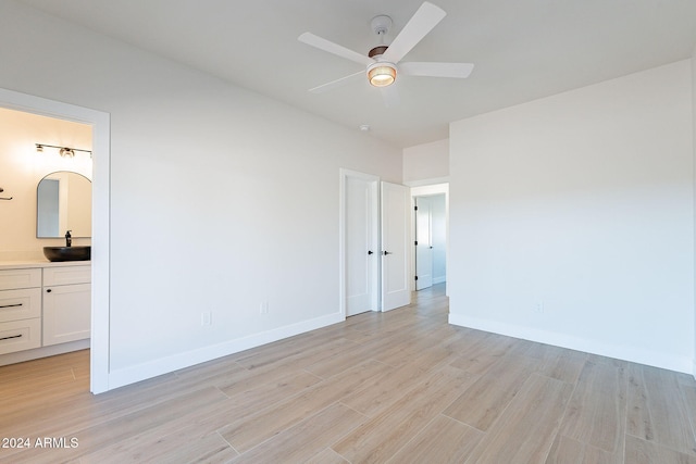 3877 S Veronica Ln, Gold Canyon, AZ 85118 - unfurnished room featuring light wood-style floors, a sink, a ceiling fan, and baseboards
