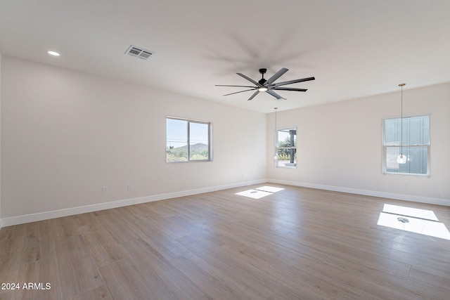 spare room featuring light hardwood / wood-style flooring and ceiling fan