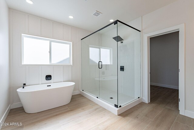 3877 S Veronica Ln, Gold Canyon, AZ 85118 - bathroom with a stall shower, a freestanding tub, wood finished floors, recessed lighting, and baseboards
