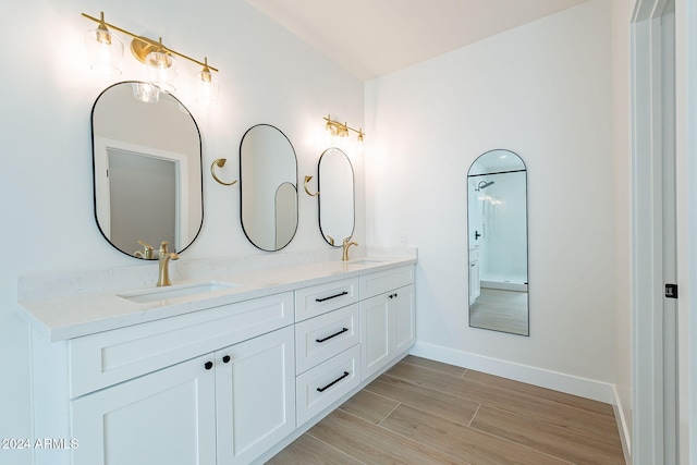 3877 S Veronica Ln, Gold Canyon, AZ 85118 - full bathroom featuring double vanity, wood finished floors, and baseboards