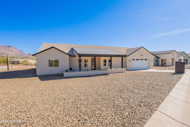 3877 S Veronica Ln, Gold Canyon, AZ 85118 - view of front of property with a garage, a porch, stucco siding, and concrete driveway