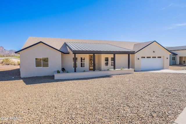 3877 S Veronica Ln, Gold Canyon, AZ 85118 - view of front of house featuring a garage, driveway, covered porch, and stucco siding