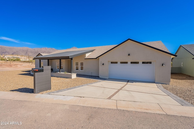 3877 S Veronica Ln, Gold Canyon, AZ 85118 - ranch-style house featuring a mountain view, an attached garage, concrete driveway, and stucco siding