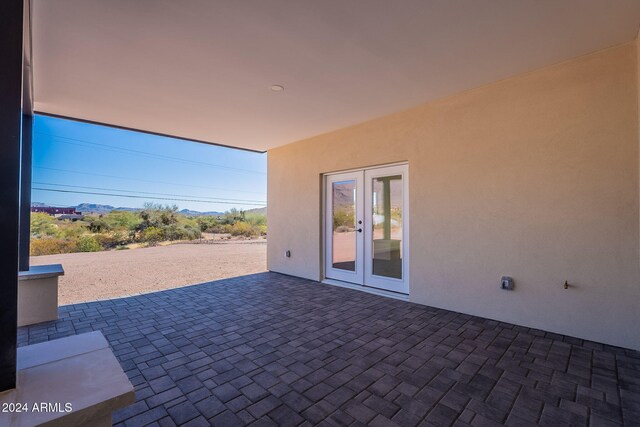 3877 S Veronica Ln, Gold Canyon, AZ 85118 - view of patio / terrace with french doors and a mountain view