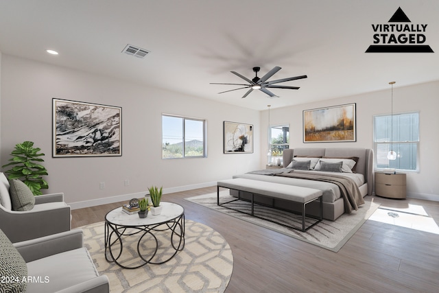 bedroom with light hardwood / wood-style flooring and ceiling fan