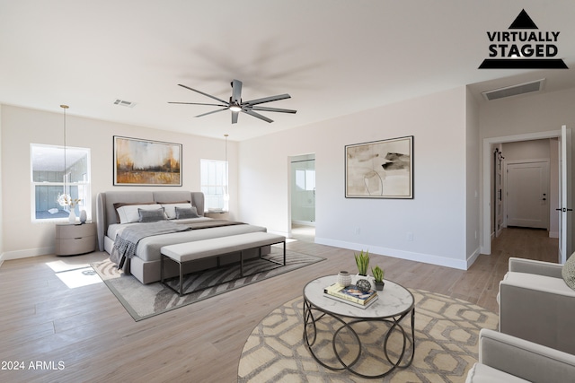 bedroom with ceiling fan, light hardwood / wood-style flooring, and multiple windows