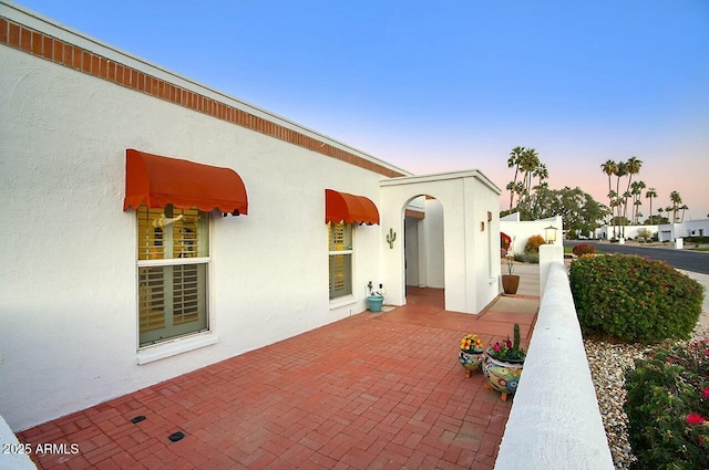 view of patio terrace at dusk