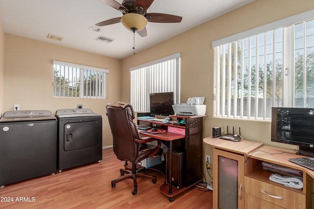 office area featuring washing machine and clothes dryer, ceiling fan, and light wood-type flooring