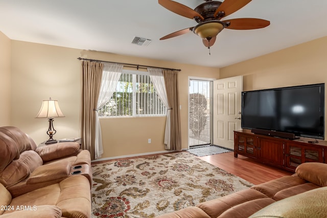 living room featuring light wood-type flooring and ceiling fan