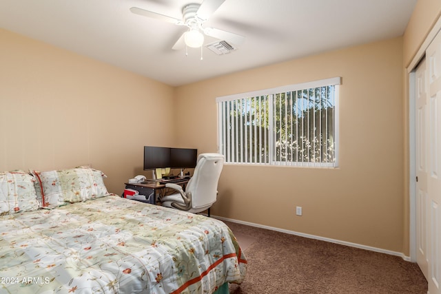 carpeted bedroom featuring ceiling fan and a closet