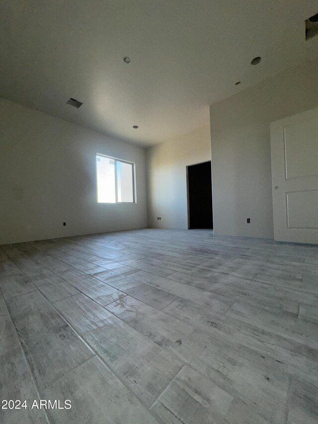 kitchen featuring white cabinetry, sink, a kitchen island, and wood-type flooring