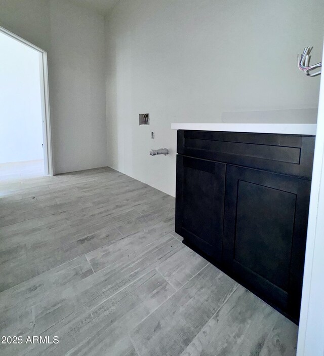 unfurnished living room with ceiling fan and light wood-type flooring