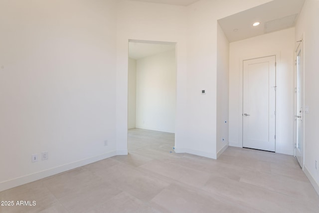 spare room featuring baseboards and recessed lighting