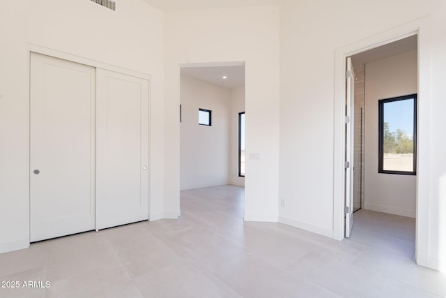 unfurnished bedroom featuring a closet, visible vents, and baseboards