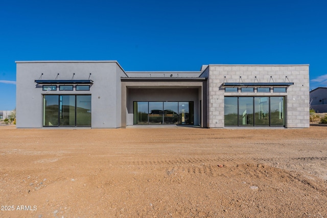 rear view of property with stucco siding