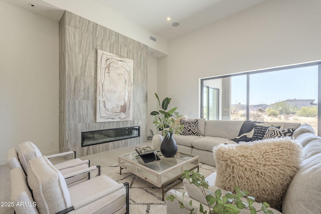 35065 N 83rd Pl Unit 4, Scottsdale, AZ 85266 - living room featuring visible vents, a towering ceiling, a high end fireplace, and recessed lighting