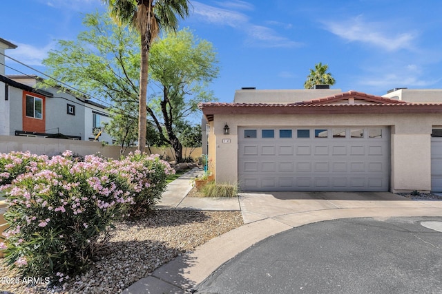 3221 N 37th St Unit 10, Phoenix, AZ 85018 - view of front facade with a tile roof, stucco siding, driveway, and an attached garage