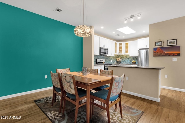 3221 N 37th St Unit 10, Phoenix, AZ 85018 - dining space featuring baseboards, recessed lighting, and light wood-style floors
