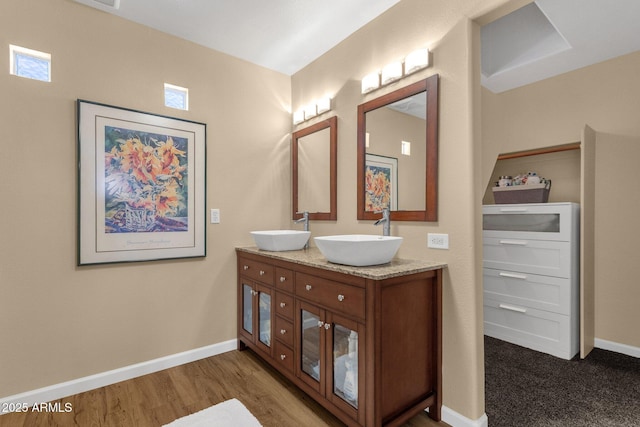 3221 N 37th St Unit 10, Phoenix, AZ 85018 - full bath featuring double vanity, baseboards, and wood finished floors