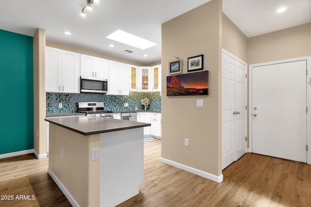 3221 N 37th St Unit 10, Phoenix, AZ 85018 - kitchen with stainless steel appliances, white cabinets, light wood-style floors, and recessed lighting