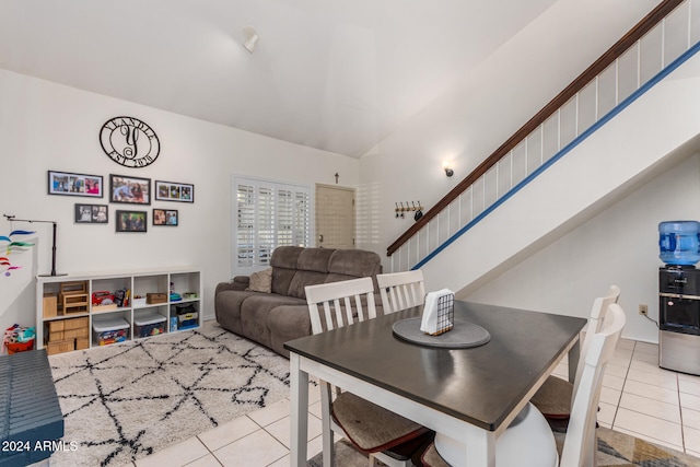 tiled dining area featuring lofted ceiling