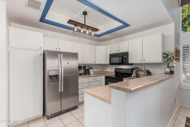 kitchen featuring decorative light fixtures, white cabinetry, and black appliances