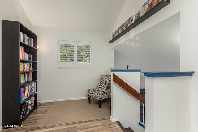 living area featuring hardwood / wood-style floors and lofted ceiling