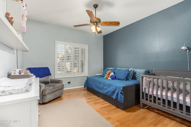 bedroom with light wood-type flooring and ceiling fan