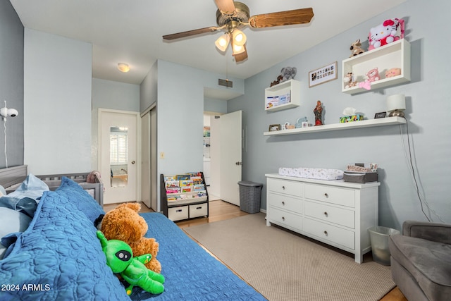 bedroom with light hardwood / wood-style flooring and ceiling fan