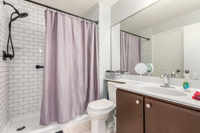 bathroom featuring curtained shower, tile patterned flooring, vanity, and toilet