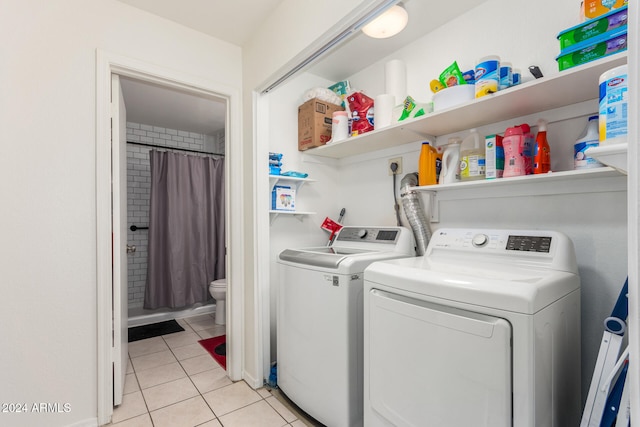 washroom featuring separate washer and dryer and light tile patterned floors