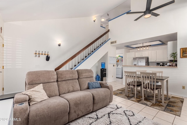 tiled living room featuring washer / dryer, high vaulted ceiling, and ceiling fan