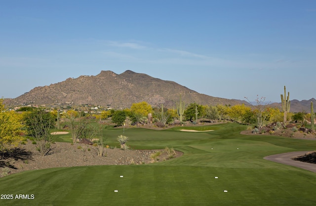 view of home's community featuring view of golf course and a mountain view