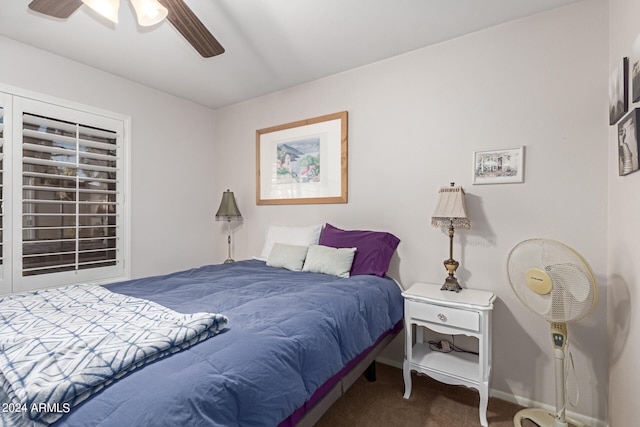 bedroom featuring ceiling fan and dark colored carpet