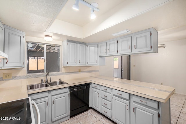 6430 W Thomas Rd, Phoenix, AZ 85033 - kitchen featuring black dishwasher, a sink, a peninsula, and light tile patterned floors