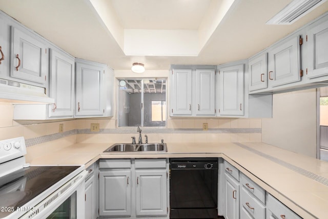 6430 W Thomas Rd, Phoenix, AZ 85033 - kitchen with white range with electric cooktop, dishwasher, a sink, under cabinet range hood, and tasteful backsplash